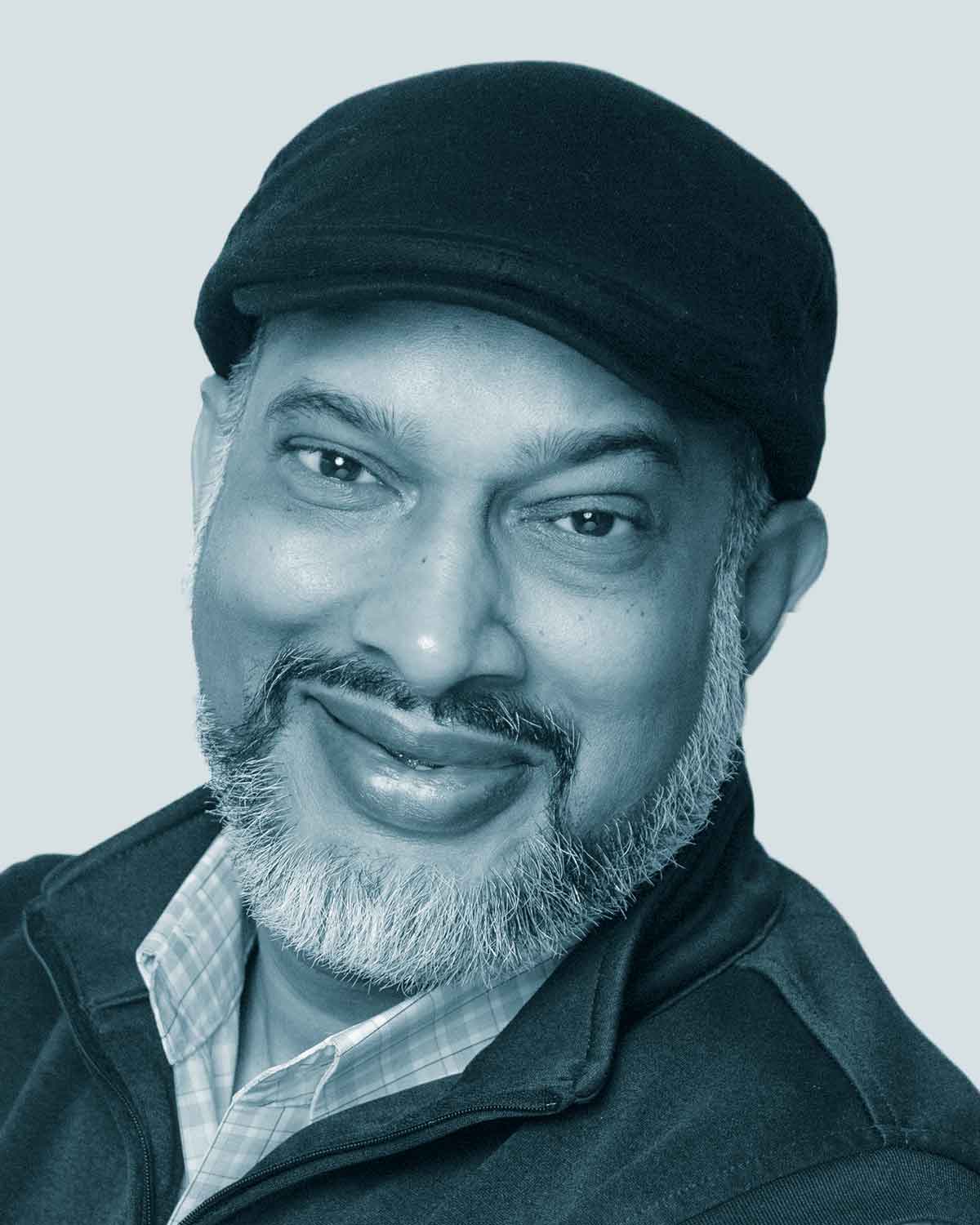 Smiling man wearing a black cap